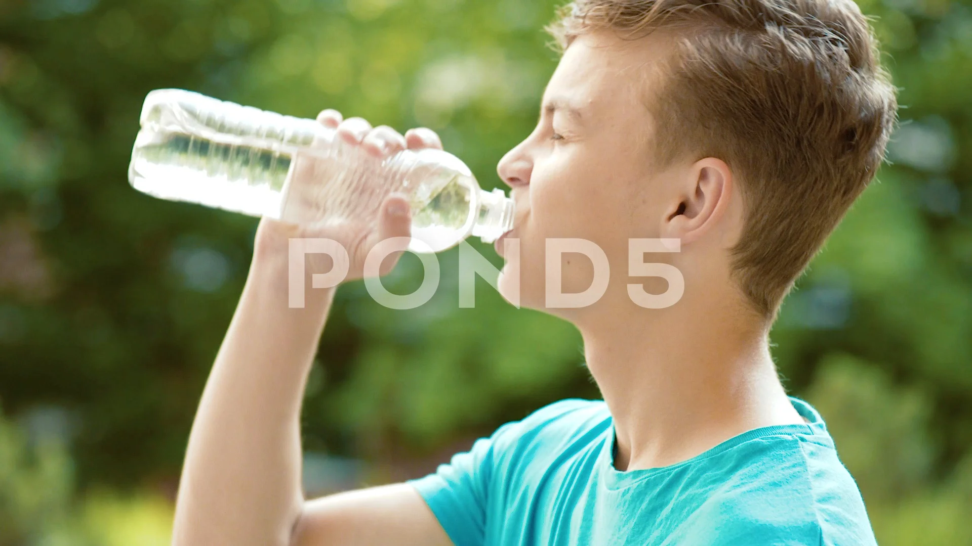Teen boy drinking water outdoors Stock Video Footage by ©VaLiza #199836514