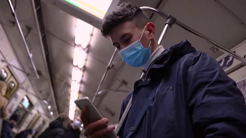 Teen boy in face mask using phone riding in metro Stock-Footage 149621872