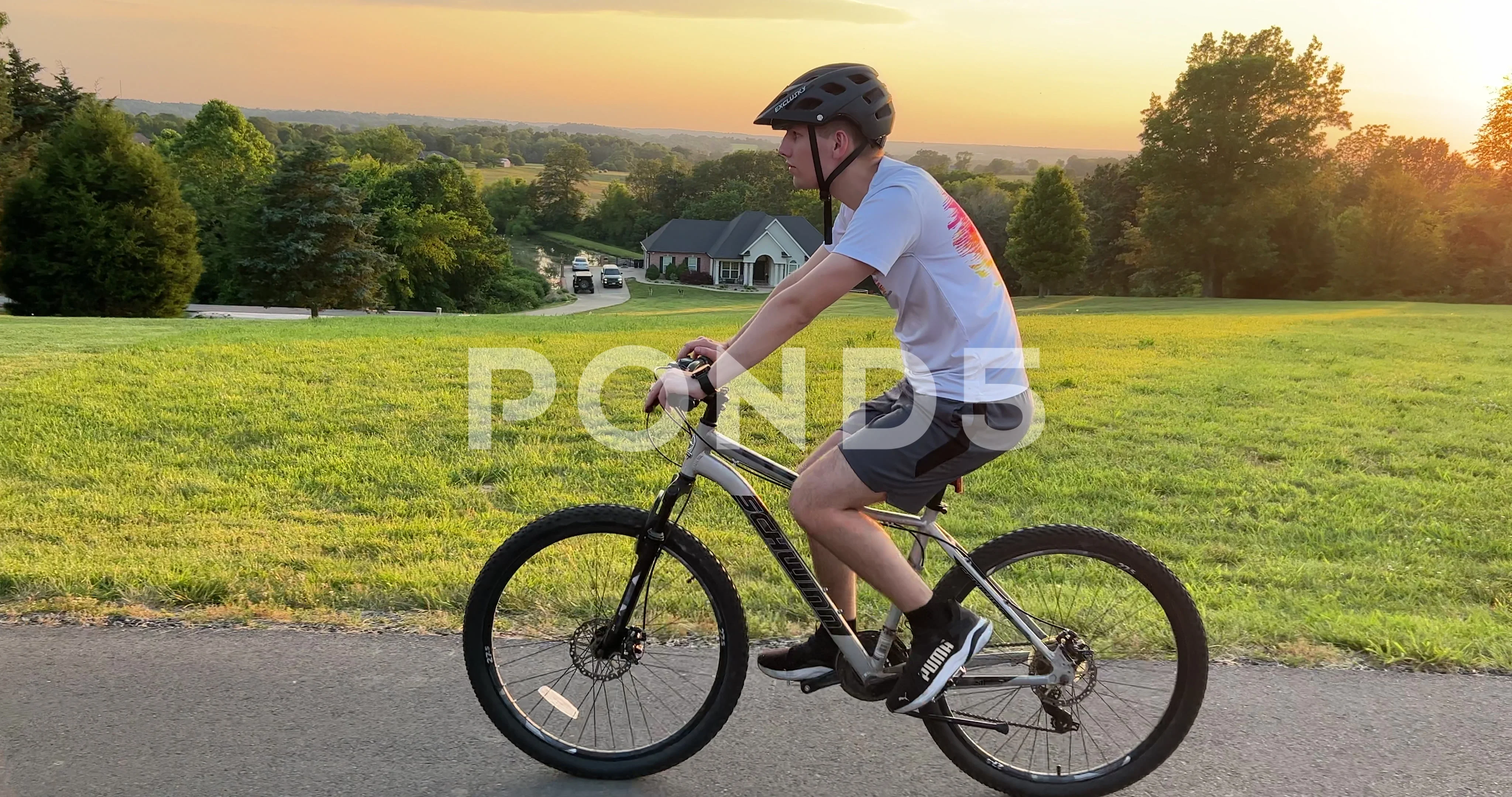 Teen boy with helmet riding bike slow Stock Video Pond5