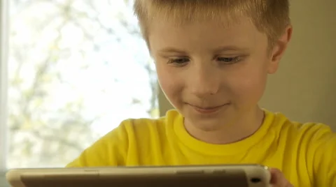 Teen boy playing touch pad Stock Footage 62467182