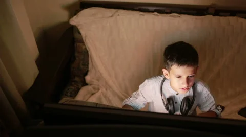 Teen boy plays games on the computer at night. Online Games Stock Footage