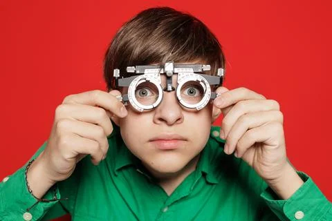 Teen Boy Testing Vision With Optometry Trial Frame On Red Stock Photos