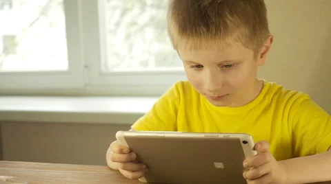 Teen boy uses a tablet PC Stock Footage 62452258