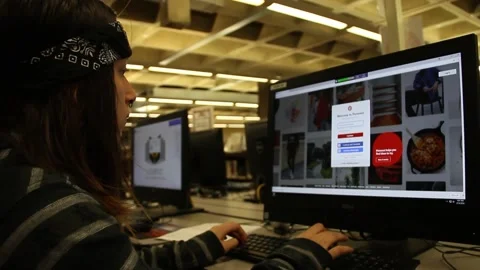 Teen on computer at library Stock Footage 134679494