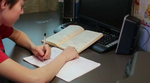 Teen doing lessons at the table Stock Footage 58259428