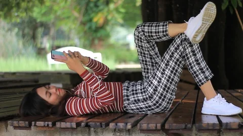 Teen Girl Lying Down While Chatting Stock Footage 121438022