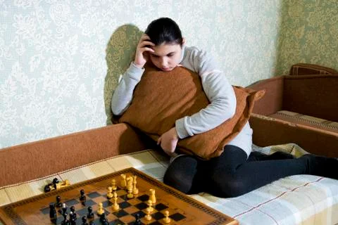 Teen girl making checkmate playing chess Stock Photos