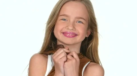 Teen girl posing on a white background and smiling, slow motion Stock Footage 62691453