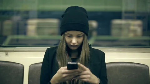 Teen girl rides the subway at night and used smartphone Stock Footage