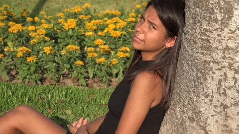 Teen Girl Sitting In Park Stock Footage