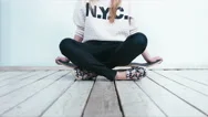Teen Girl Sitting On A Skateboard. 4K Cinemagraph - Motion Photo Seamless Loop Stock Footage