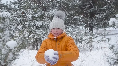 Teen girl throwing snow with her hands, happy girl laughs rejoices family Stock Footage