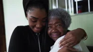 A Teen Granddaughter Embracing Grandmother A Black Girl Embraces Grandparent Stock Footage