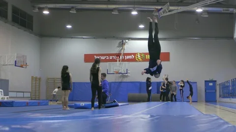 Teen gymnastics pro exercise sequence training front long shot Stock Footage 106042072