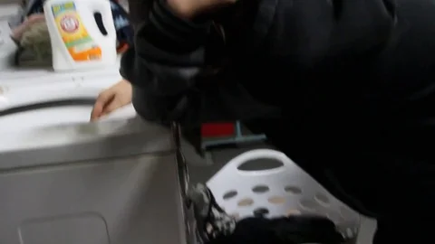 Teen hates doing laundry Stock Footage 79047329
