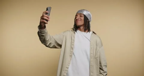 Teen interacts with smartphone in studio setting while showing different ex.. Stock Footage 331989725