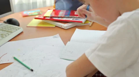 Teen makes lessons at a computer desk Stock Footage 61583354