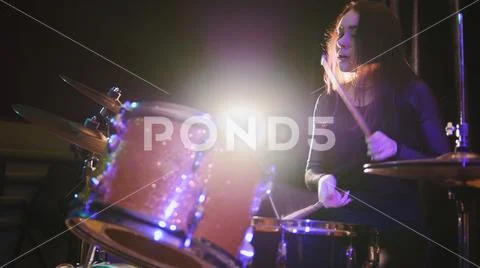 Teen rock music - sensual girl with flowing hair percussion drummer perform.. Stock Photos