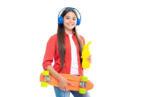 Teen school girl with skateboard water bottle and headphones on studio isolated Stock Photos