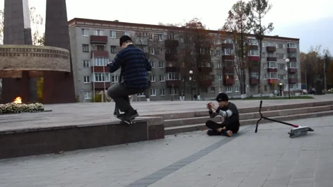 Teen on scooter performs a tricks Stock Footage 280348725
