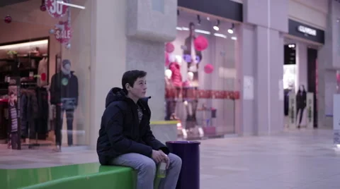 Teen sitting on a bench and drinking lemonade Stock Footage 59559561
