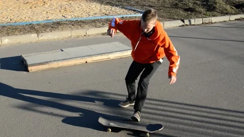 Teen on skateboard performs a trick Stock Footage