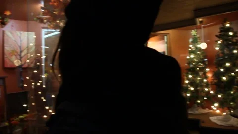 Teen staring into window as camera pans to Christmas tree display Stock Footage 83280568