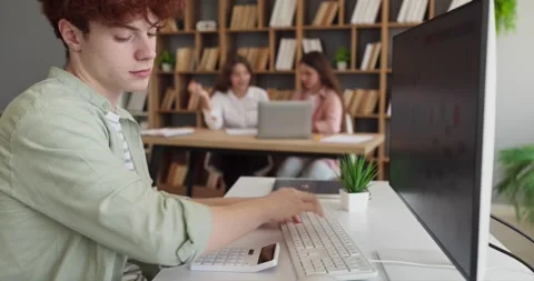 Teen student analyzing data charts on computer in classroom for research project Stock Footage 338434173