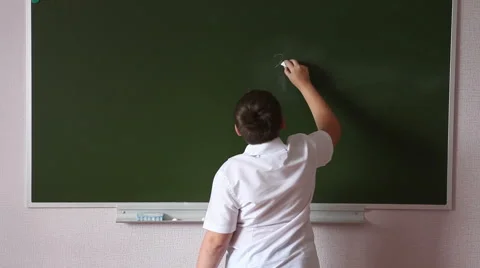 Teen student solves an example on the blackboard Stock Footage 64747176