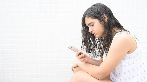 Teen using cellphone Stock Footage 94528573
