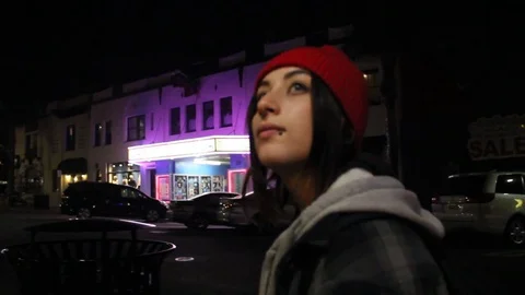 Teen walks through empty town at night Stock Footage 80806893