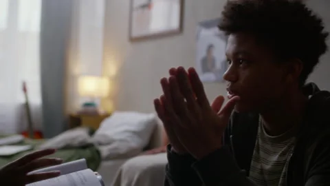 Teenage Black Boy Avoiding Eye Contact during Home Interview with Social Worker Stock Footage 329682940