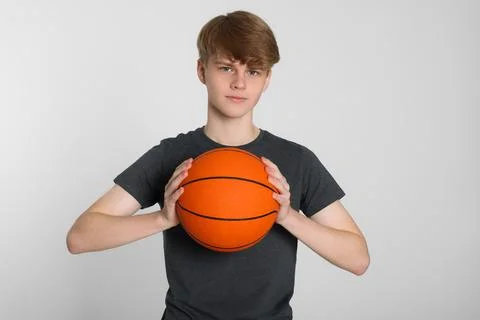Premium Photo  Adorable boy child throwing a ball while playing basketball.  isolated portrait of a young basketball player