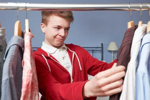 Teenage Boy Choosing Clothes From Wardrobe Stock Photos