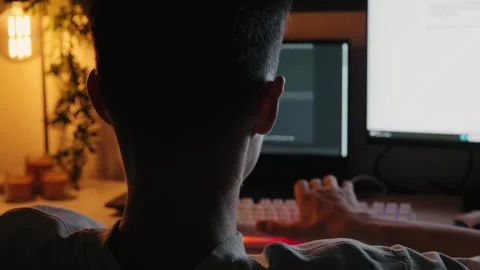 Teenage Boy Coding and Typing on Computer at Desk at Night 库存影片 344967788