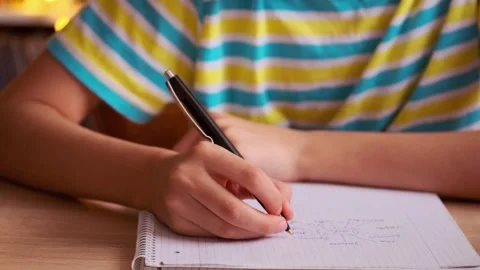 Teenage boy creates mind map, teen sketches ideas on graph paper, draws fam.. Stock Footage 310358324
