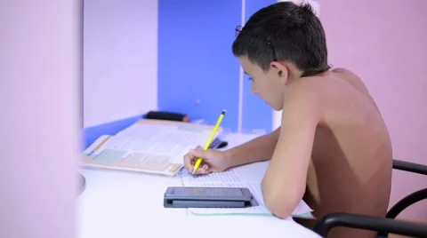 Teenage boy doing homework using a cell phone. natural video Stock Footage 67363220