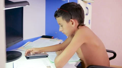 Teenage boy doing homework using a cell phone. natural video Stock Footage 67546020