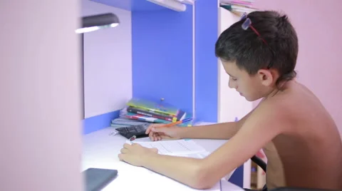 Teenage boy doing homework using a cell phone. natural video Stock Footage 67548048