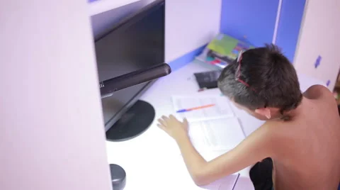 Teenage boy doing homework using a cell phone. natural video Stock Footage 67548509