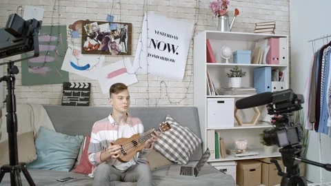 Teenage Boy Filming Ukulele Tutorial 動画素材 88710712