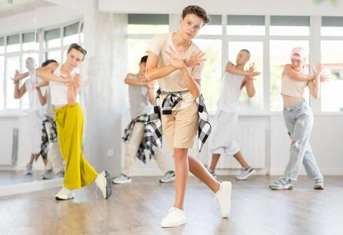 Teenage boy practicing basic hip hop moves in training hall 스톡 사진