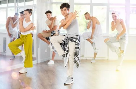 Teenage boy practicing basic hip hop moves in training hall 写真素材