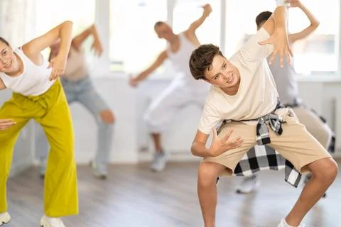 Teenage boy practicing basic hip hop moves in training hall 스톡 사진