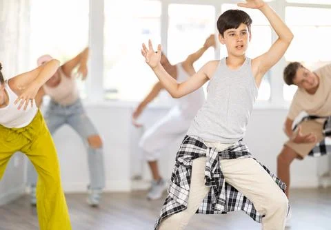Teenage boy practicing basic hip hop moves in training hall 스톡 사진