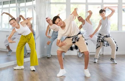Teenage boy practicing basic hip hop moves in training hall 스톡 사진