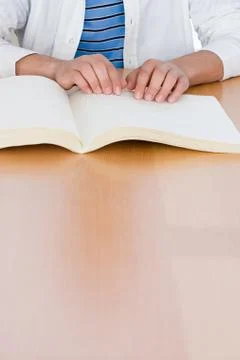 Teenage boy reading a braille book Stock Photos