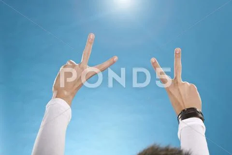 Teenage boy showing peace symbol Stock Photos