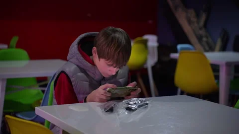 Teenage boy sitting alone using smartphone for gaming and entertainment. Co.. Stock Footage 338188887