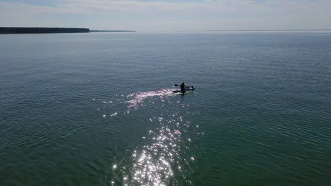 Teenage boy sitting on paddleboard Stock Footage 113946053
